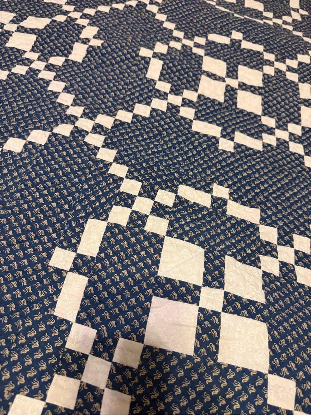 handmade patchwork quilt features the traditional Burgoyne Surrounded pattern